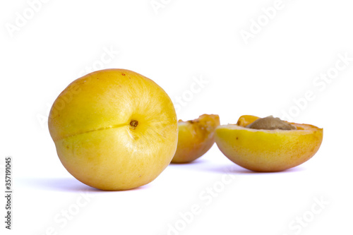 Ripe sweet apricots on white background. Fresh whole fruit and two half parts behind. Fresh healthy food, vegetarian, paleo diet. Food ingredient. Fruits and vegetables.