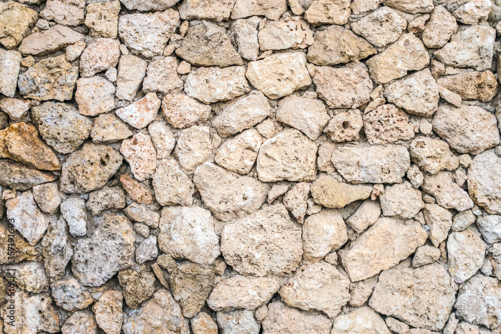 Old stone masonry. Background image of a historical wall. Stone wall from Sandstone. Old stone masonry. Background image of a historical wall. Stone wall from Sandstone.