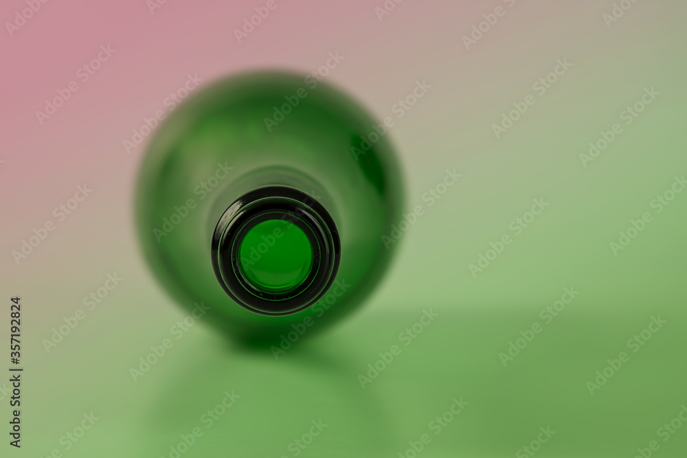 green wine bottle on pink background
