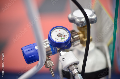 Shalow depth of field detail with pressure gauge connected to an oxygen tube from a medical ventilator (respirator).