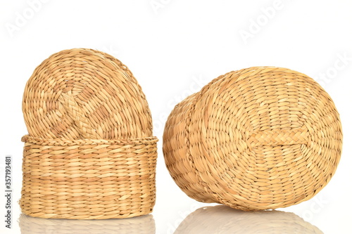 Baskets woven from natural straw, on a white background