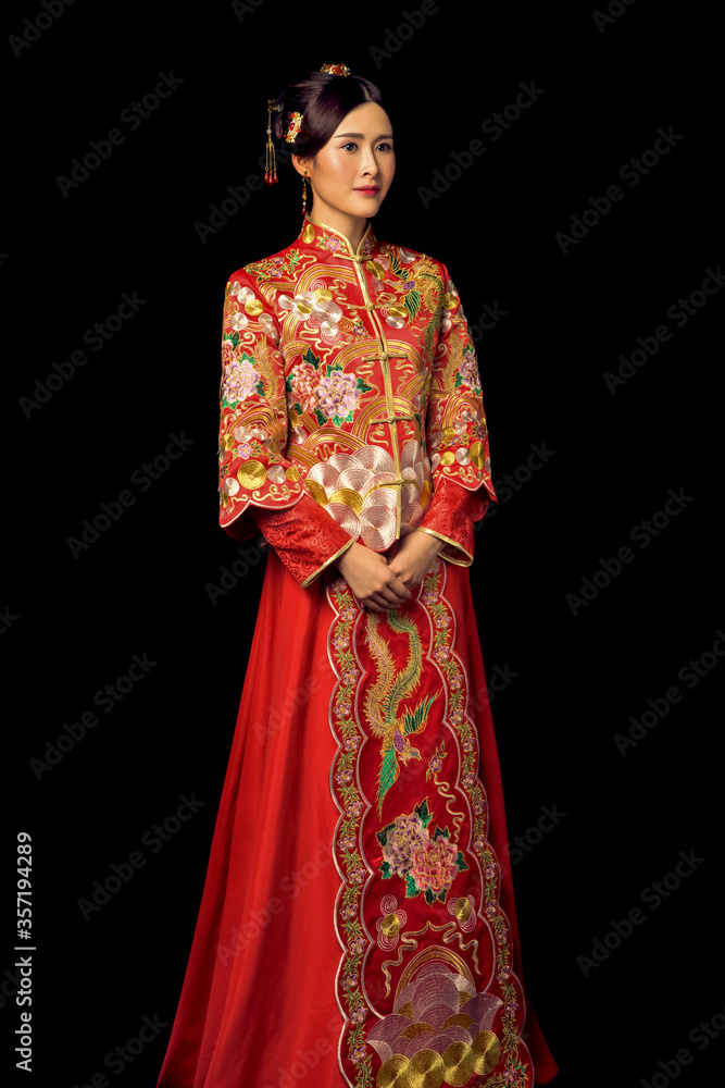 Girl wearing ancient Asian bride dress in black background