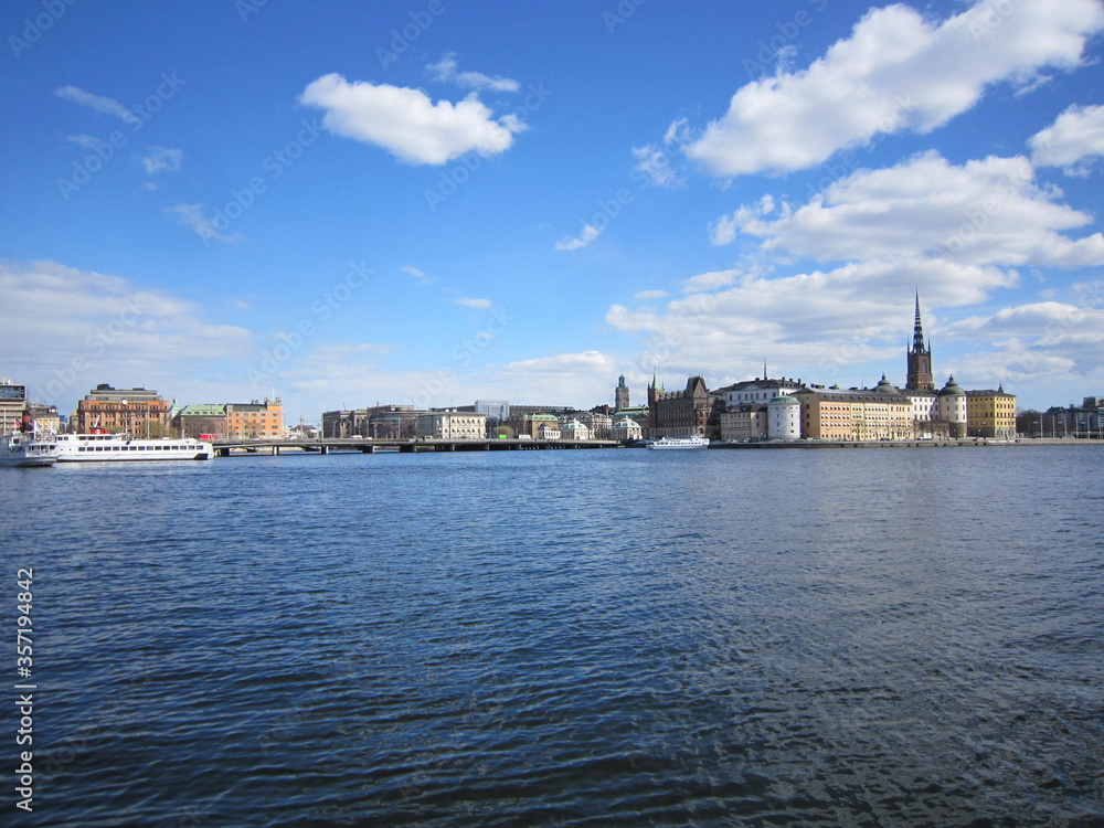 Blue water focus from the ground level with Stockholm old town (Gamla Stan) on background, Landscape of Gamla Stan, Sweden.