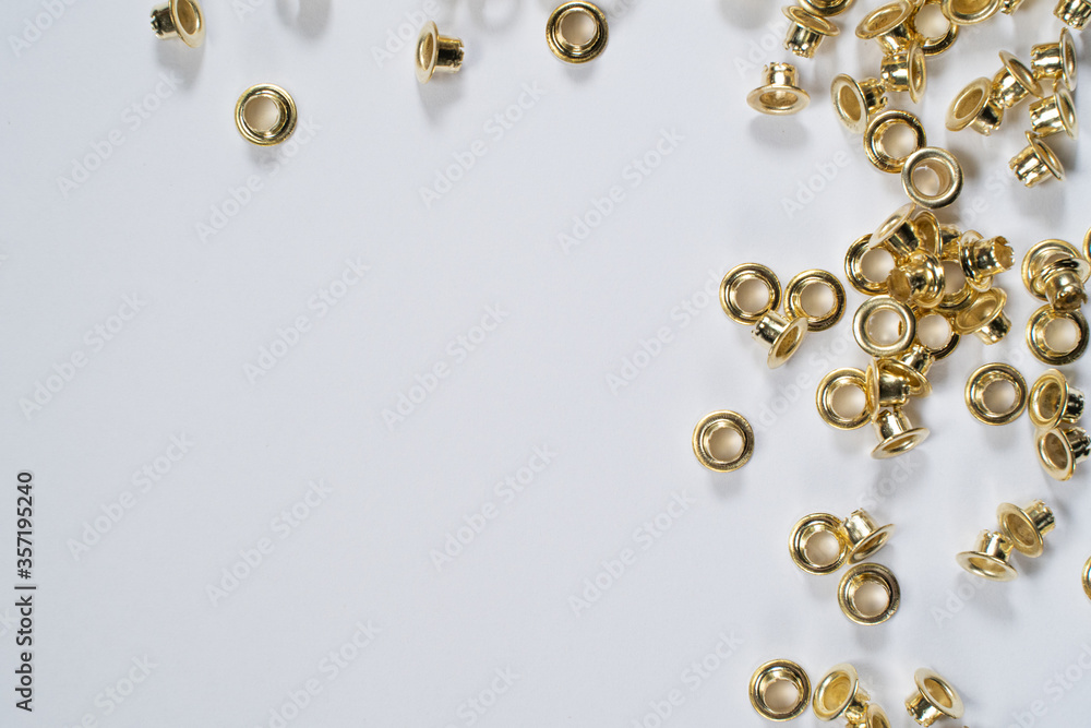 rivets scattered on a white sheet lying on table rivets scattered on a white sheet lying on table