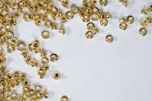 rivets scattered on a white sheet lying on table