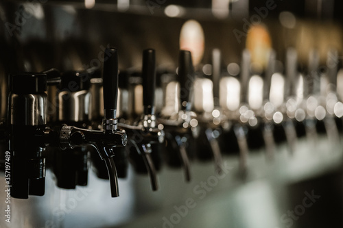 metallic beer taps in a empty bar. High quality photo