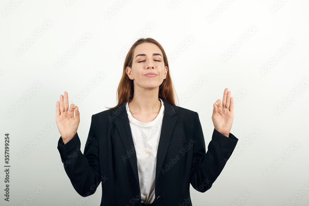 View of hand fingers showing ok sign, gesturing making okay, human emotions, facial expressions, feelings. Young attractive woman with brown hair in light t-shirt and black jacket on white background View of hand fingers showing ok sign, gesturing making okay, human emotions, facial expressions, feelings. Young attractive woman with brown hair in light t-shirt and black jacket on white background