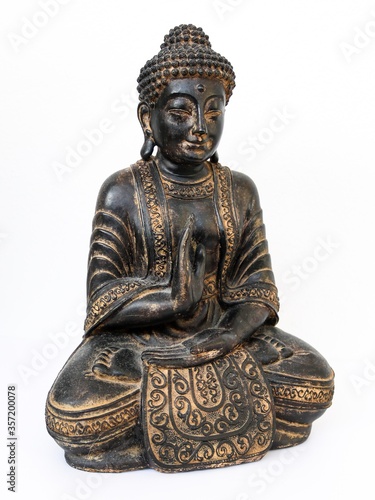 Close-up of Buddha statue sitting in meditation isolated on white background