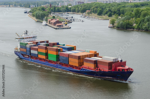 CONTAINER SHIP - Merchant vessel sails through the port channel on a sea voyage

