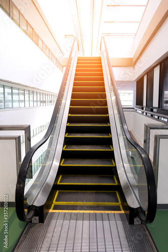 Single escalator for customer service in public building with lighting effect.
