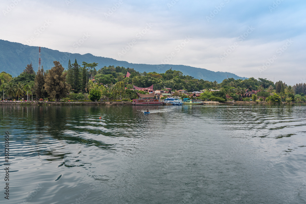 The island Samosir and peninsula Tuktuk Siadong with its resorts, within the Lake Toba, the biggest volcanic lake in the world located in the middle of the northern part of the island of Sumatra 