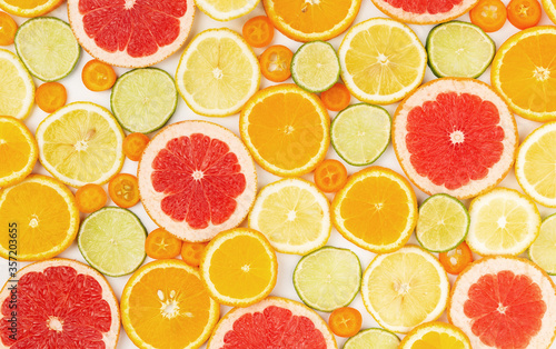 Various citrus fruits slices pattern on white background.