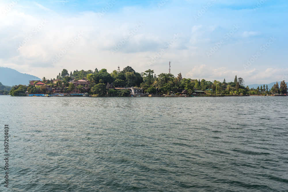 Fototapeta premium The island Samosir with the peninsula Tuktuk Siadong within the Lake Toba, the biggest volcanic lake in the world located in the middle of the northern part of the island of Sumatra 