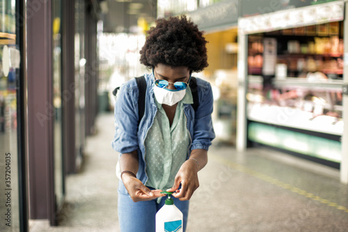 A girl is disinfecting her hands photo