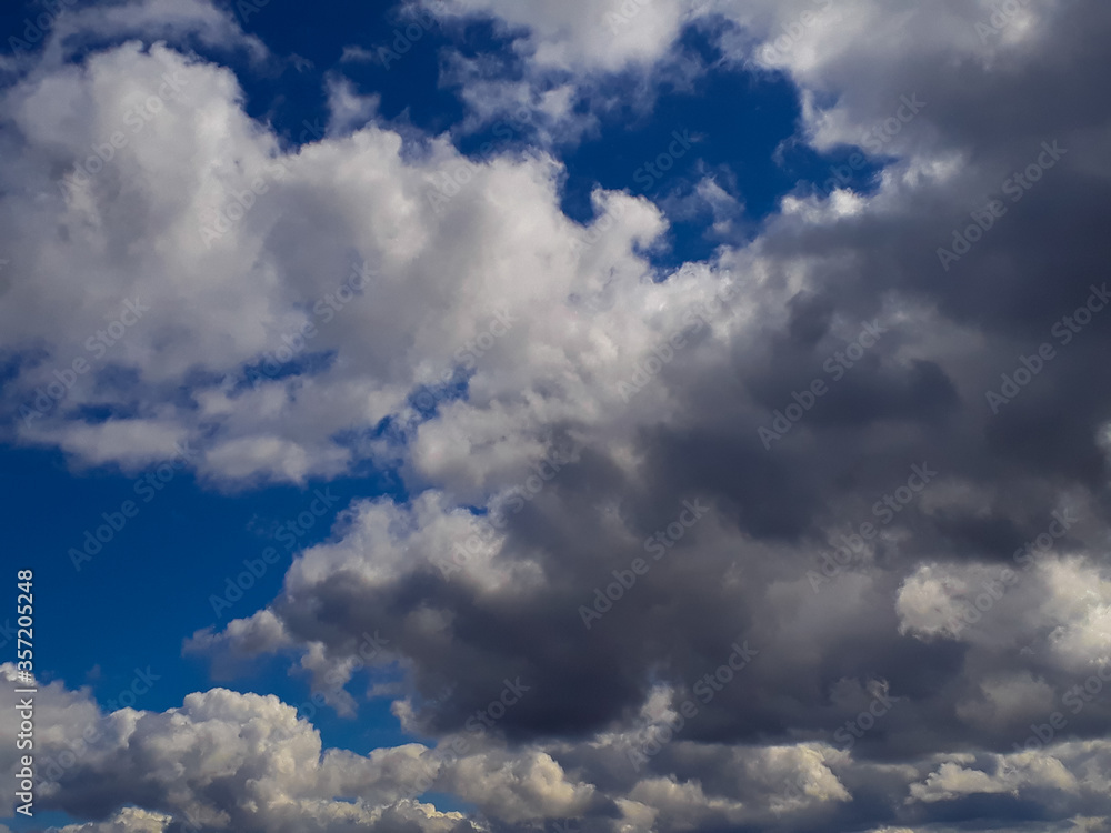 Heavy gray rain clouds in the blue sky. Atmosphere, air, cloudy, soon rain. Heavy gray rain clouds in the blue sky. Atmosphere, air, cloudy, soon rain.