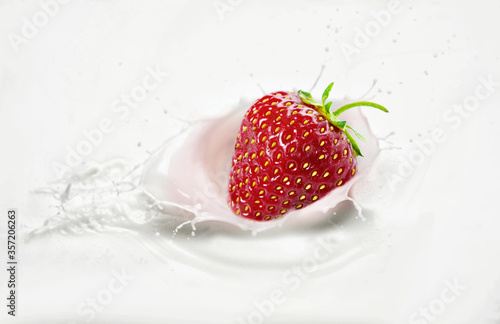 Strawberries in milk with splashes