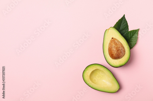 Ripe fresh avocado on pink background, top view