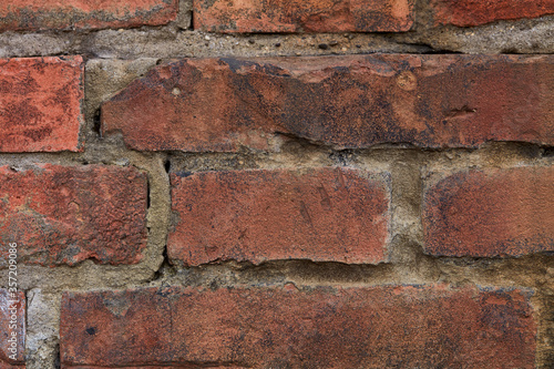 detail of very old red brick wall