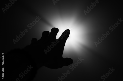 Hand finger silhouette hope help grab light  black and white