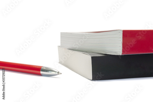 Red pen and two books with modern soft covers isolated on white background. Studying, reading, publishing, writing. Literature, self education, planner, album. Copy space.