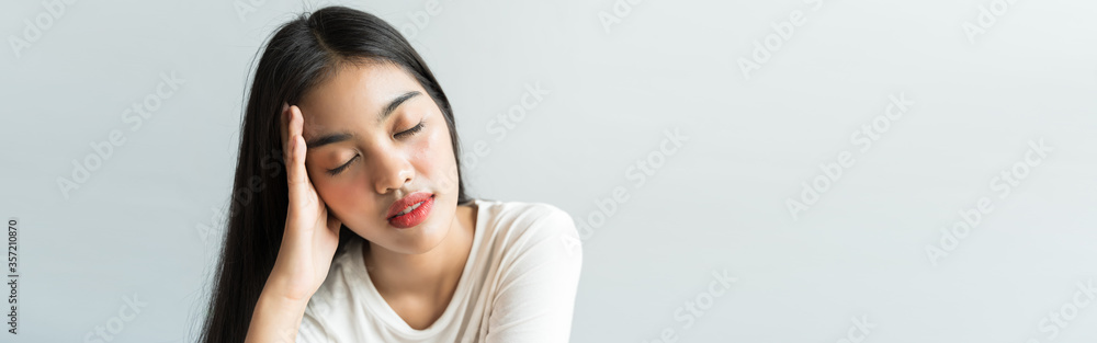 Banner Asian are holding their heads because of headaches in healthy concept with copy space Banner Asian are holding their heads because of headaches in healthy concept with copy space