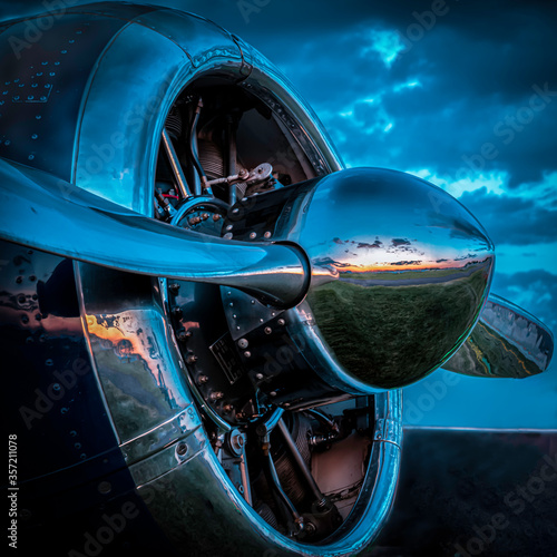 A T-6 Texas at the Oshkosh Air Show in 2019 reflects in the setting sun 