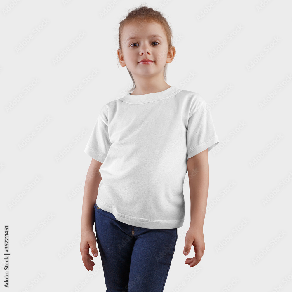 Mockup of white clothing on posing cute kid in blue jeans, isolated on background in studio, front view. Mockup of white clothing on posing cute kid in blue jeans, isolated on background in studio, front view.