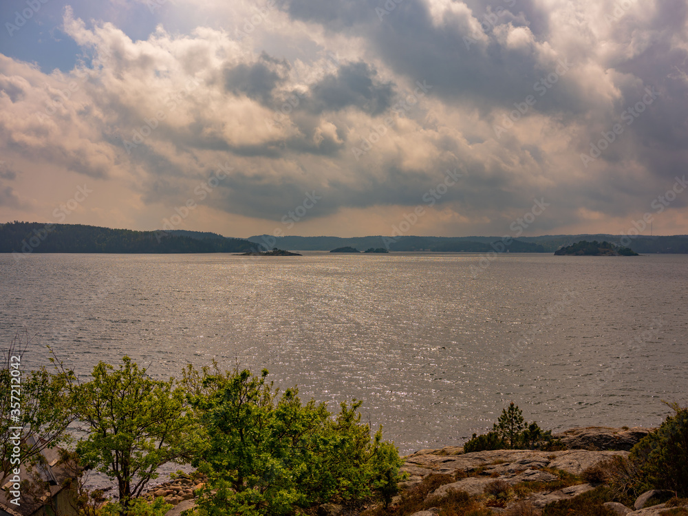 Seascape with coastline and remote islands and dramatic clouds in Sweden