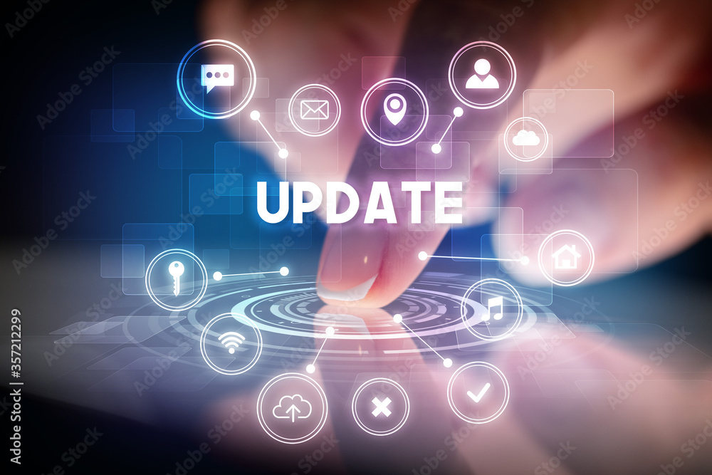 Finger touching tablet with web technology icons and UPDATE inscription, web technology concept Finger touching tablet with web technology icons and UPDATE inscription, web technology concept