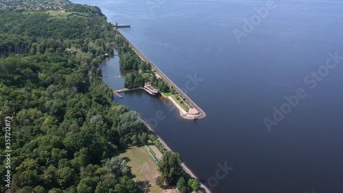 Aerial view. A large exotic wooden ship is located near the shore. Green lagoon. Kiev, Mezhyhirya. Drone
