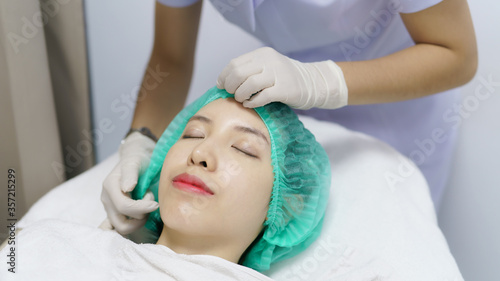 Woman lies on a couch in a cosmetics salon and prepares for a facial cleansing procedure.