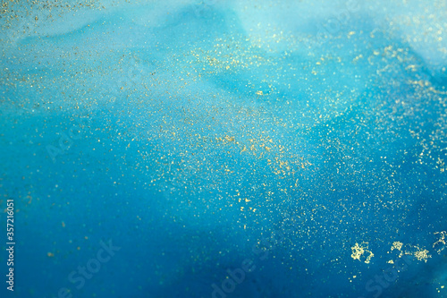 Soft focus Abstract painting background. Blue colors with gold glitter. Marble texture.
