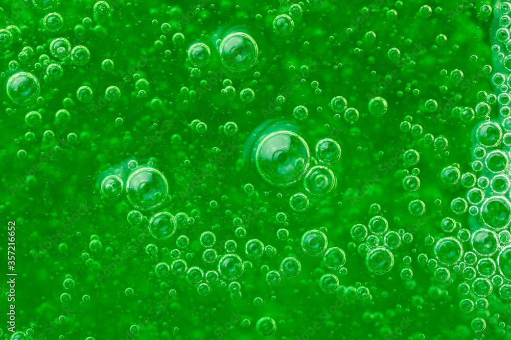abstract liquid soap bubbles green background