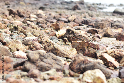 Rugged rock, brown sea soft focus.