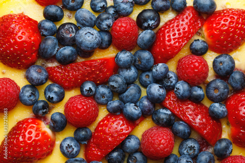 cheesecake with strawberries and blueberries, close-up view