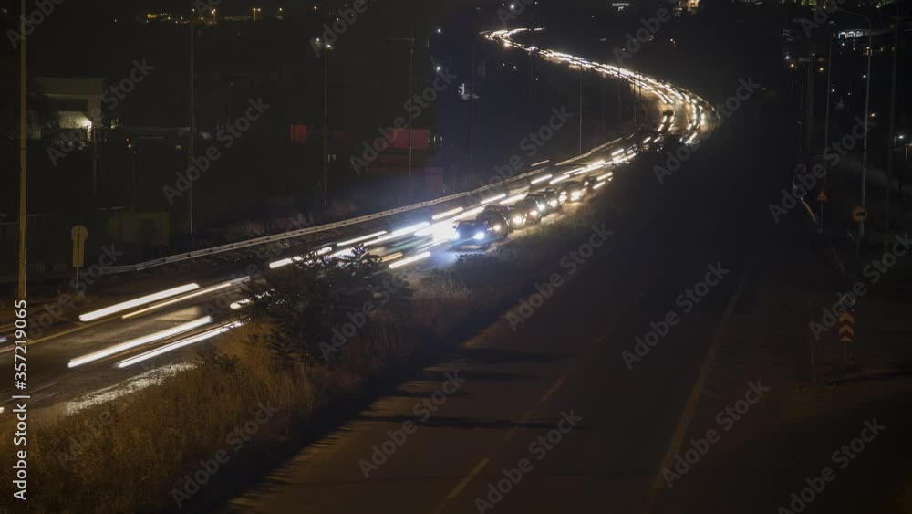 Time lapse or timelapse view of night highway with car traffic and blurry lights when long exposure