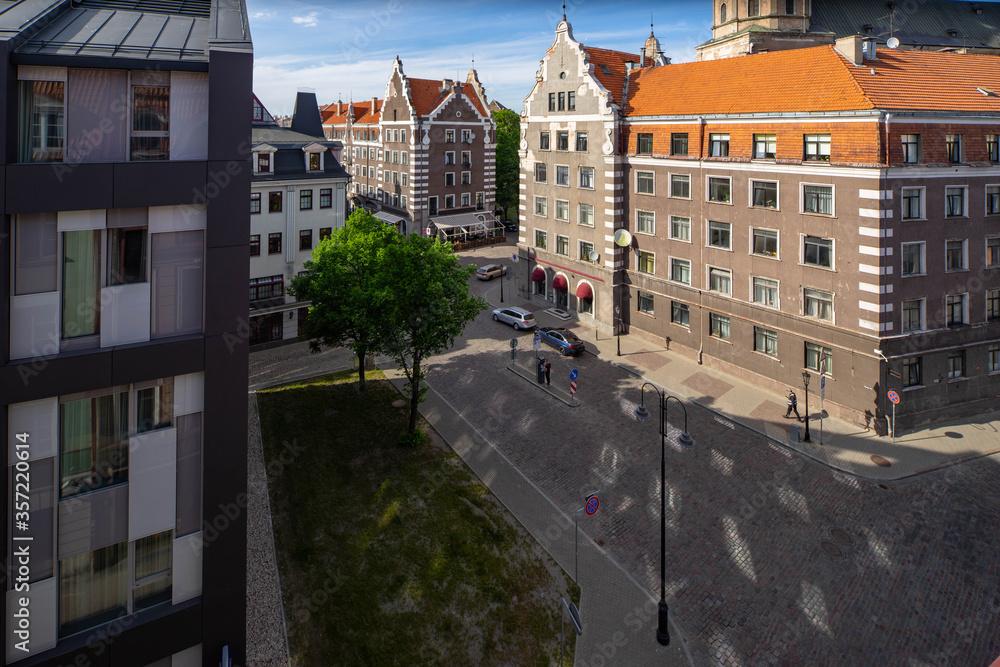 Obraz premium Tourism in Europe. Old town of Riga, Latvia. Modern and traditional architecture. Top view of a paved road.