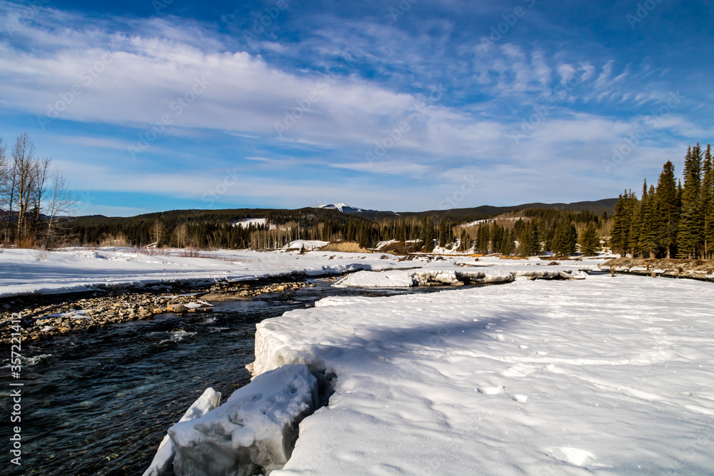 Water starting to peak through the river in late winter. Allan Bull Provincial Recreation Area. Alberta, Canada