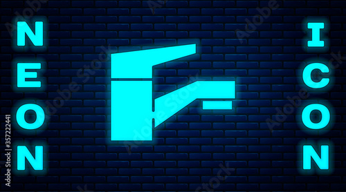 Glowing neon Water tap icon isolated on brick wall background. Vector Illustration.
