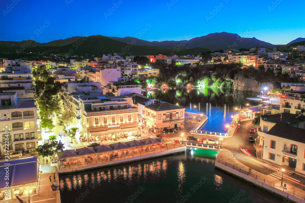 The lake Voulismeni in Agios Nikolaos,  a picturesque coastal town with colorful buildings around the port in the eastern part of the island Crete, Greece