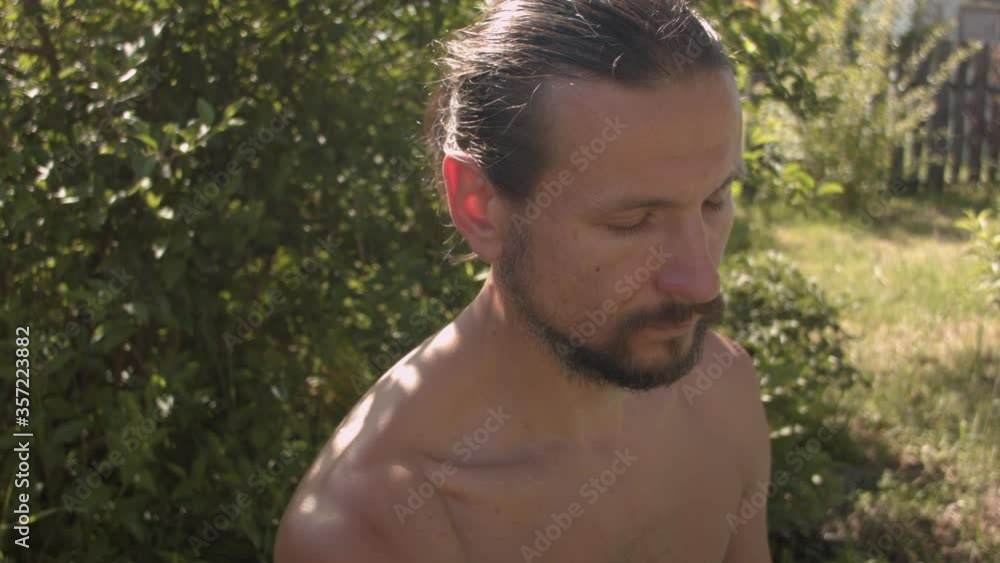 Young Caucasian man practicing yoga in his garden. Young Caucasian man practicing yoga in his garden.