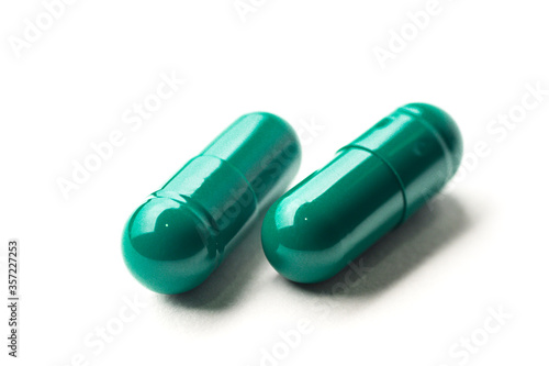 green pills on white background