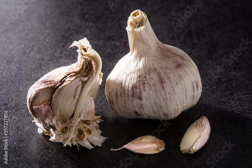 Fresh organic garlic on black background