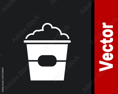 White Popcorn in cardboard box icon isolated on black background. Popcorn bucket box. Vector Illustration.
