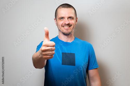 Man looking in camera and show thumbs up