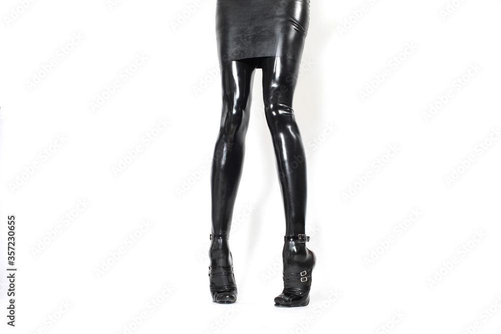 Black female latex legs in high heels with a latex skirt Black female latex legs in high heels with a latex skirt
