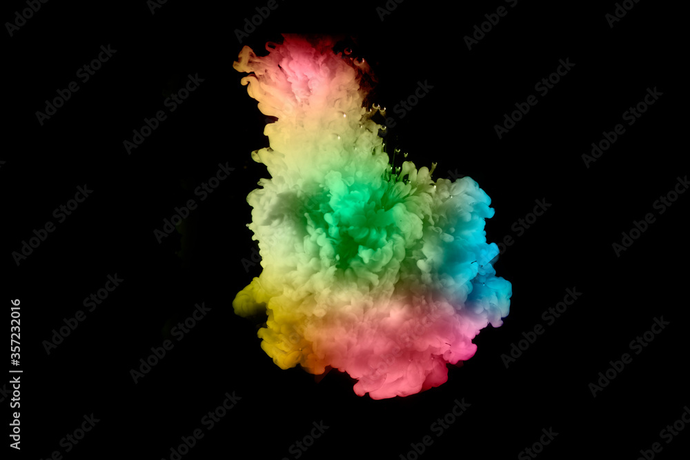 Colorful paint drops from above mixing in water. Ink swirling underwater. on background black