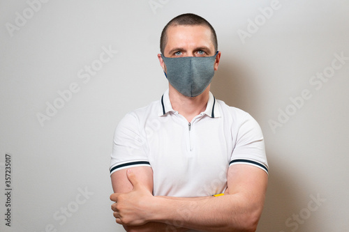 Man in protective mask and white tshirt looking in camera