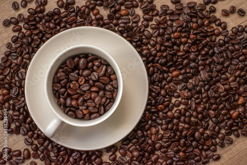 roasted coffee beans, mugs,wood background