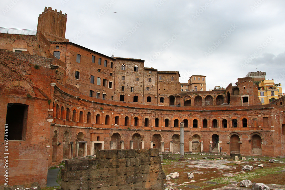 
View on the Forum of Augustus in Rome. Ruins and cloudy sky. Dominant of the orange color.